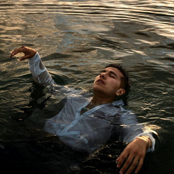 Woman meditating peacefully in a calm, minimalist environment.